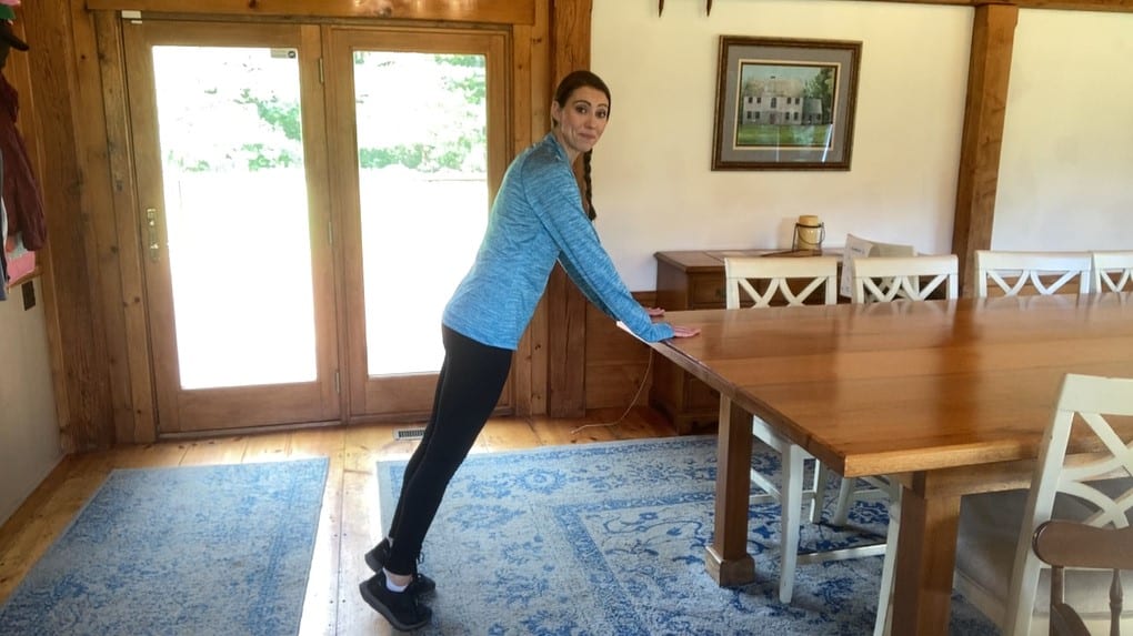 physical therapist demonstrating an adapted plank for people with MS