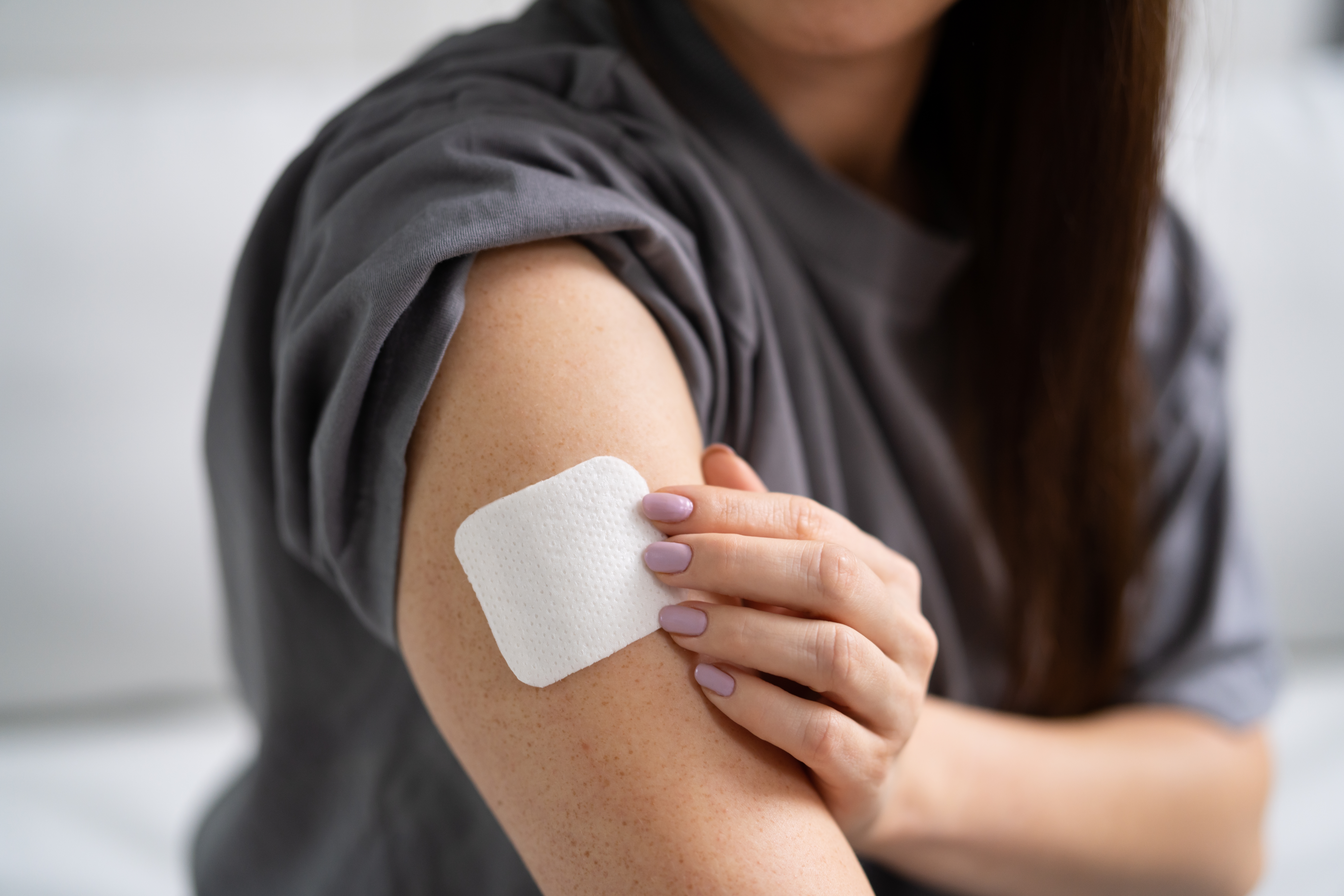 WomanPuttingOnNicotinePatch