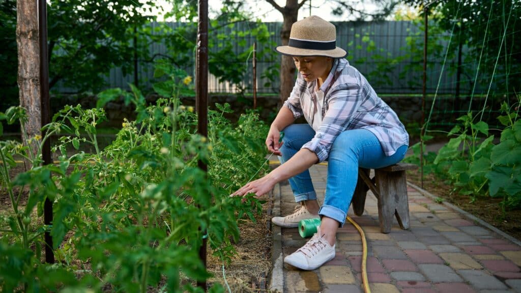 Woman sitting on a stool while gardening