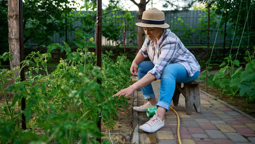 Woman sitting on a stool while gardening