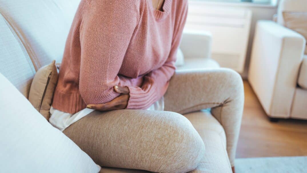 Woman clutching abdomen in pain