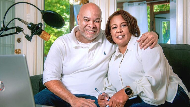 Man and woman sitting on couch together smiling