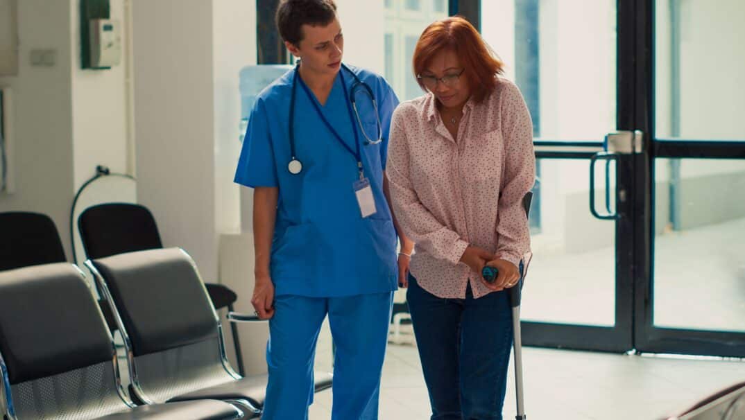 Woman with walking impairment with nurse