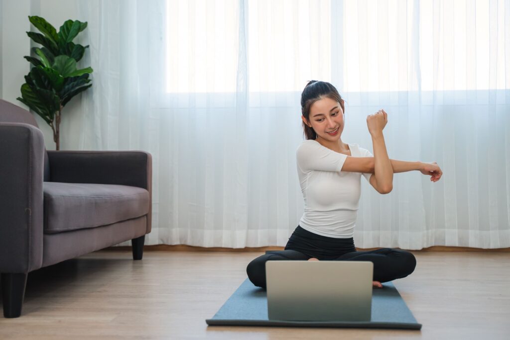 Young woman doing virtual yoga