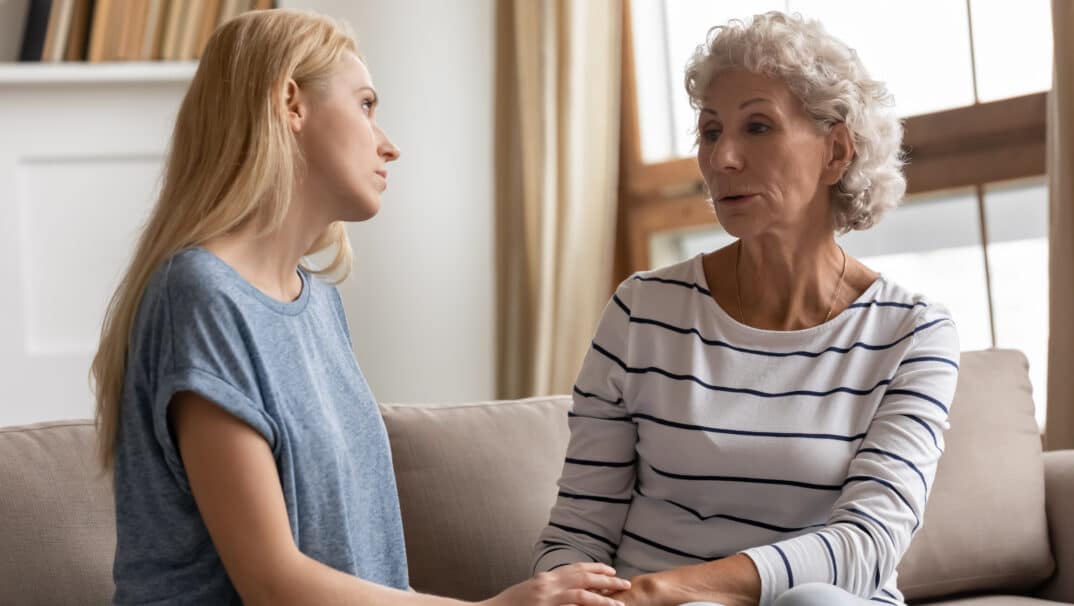 Adult Mother and Daughter Talking on Couch