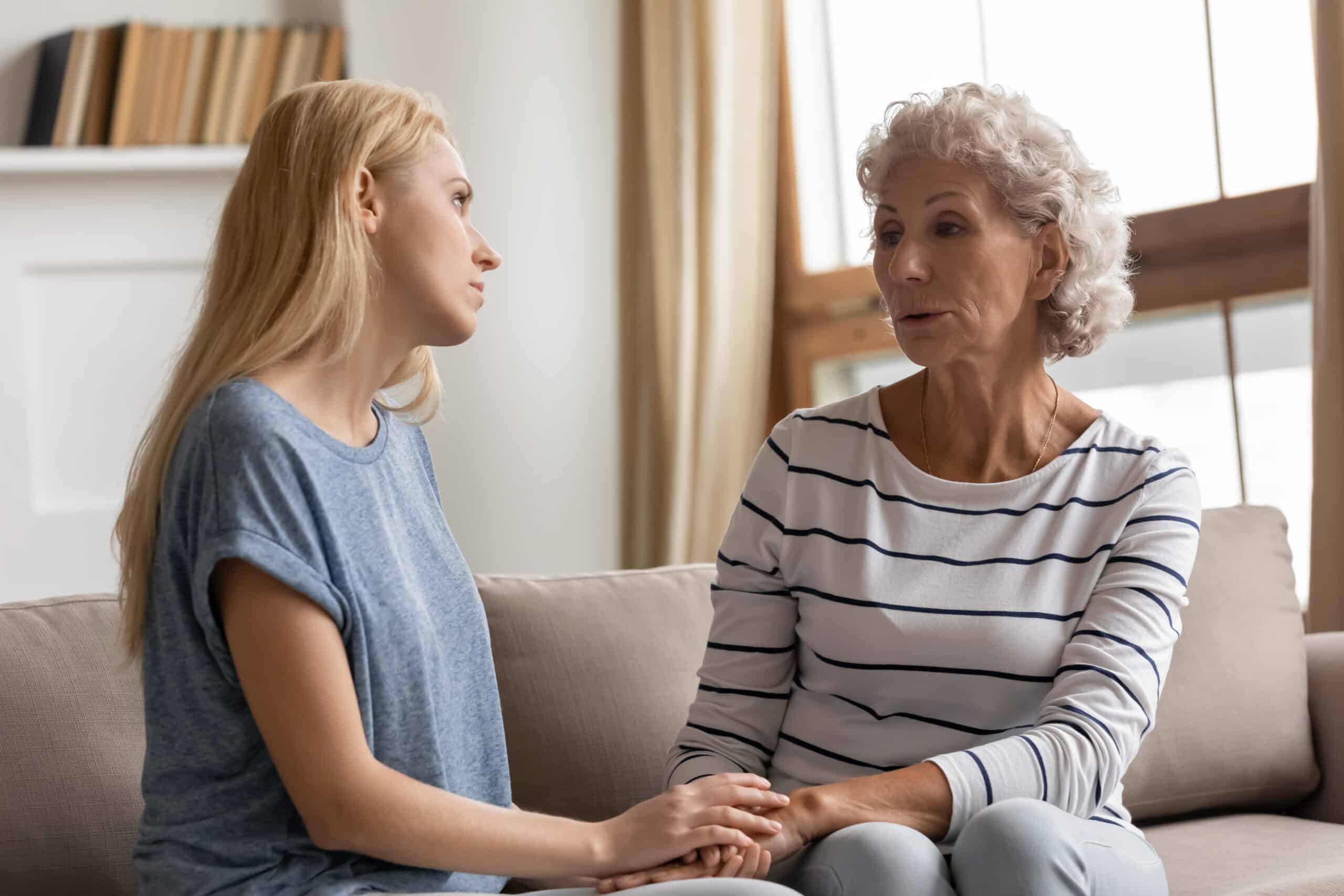 Adult Mother and Daughter Talking on Couch