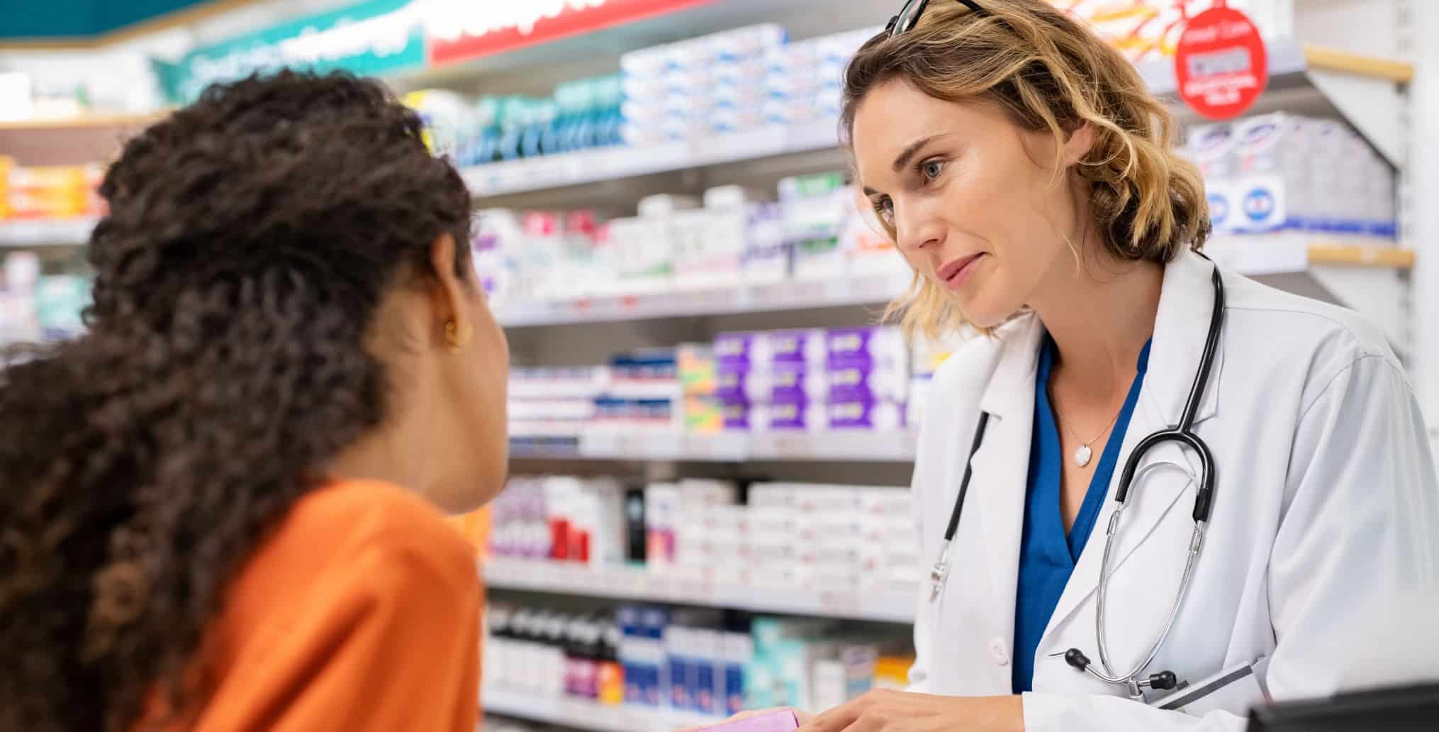 Pharmacist talks with patient