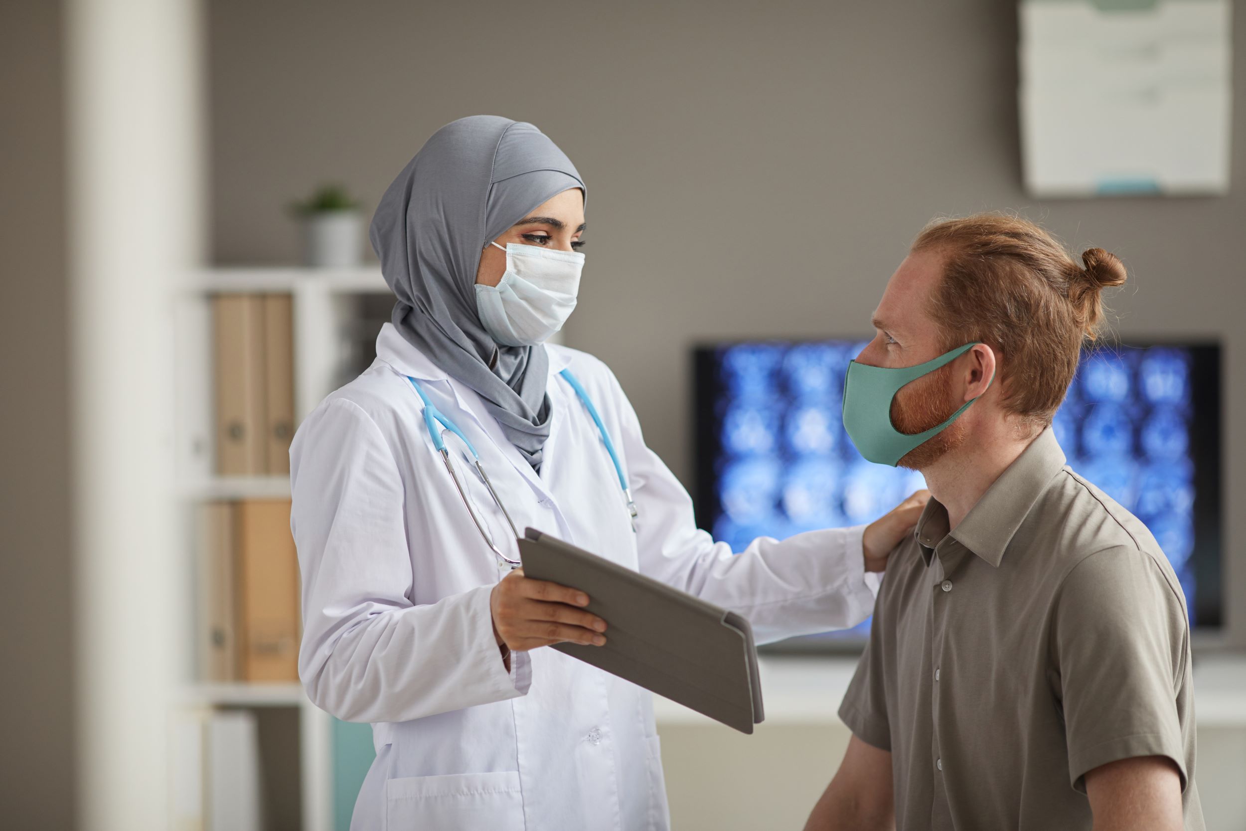 Female doctor talking with a male patient