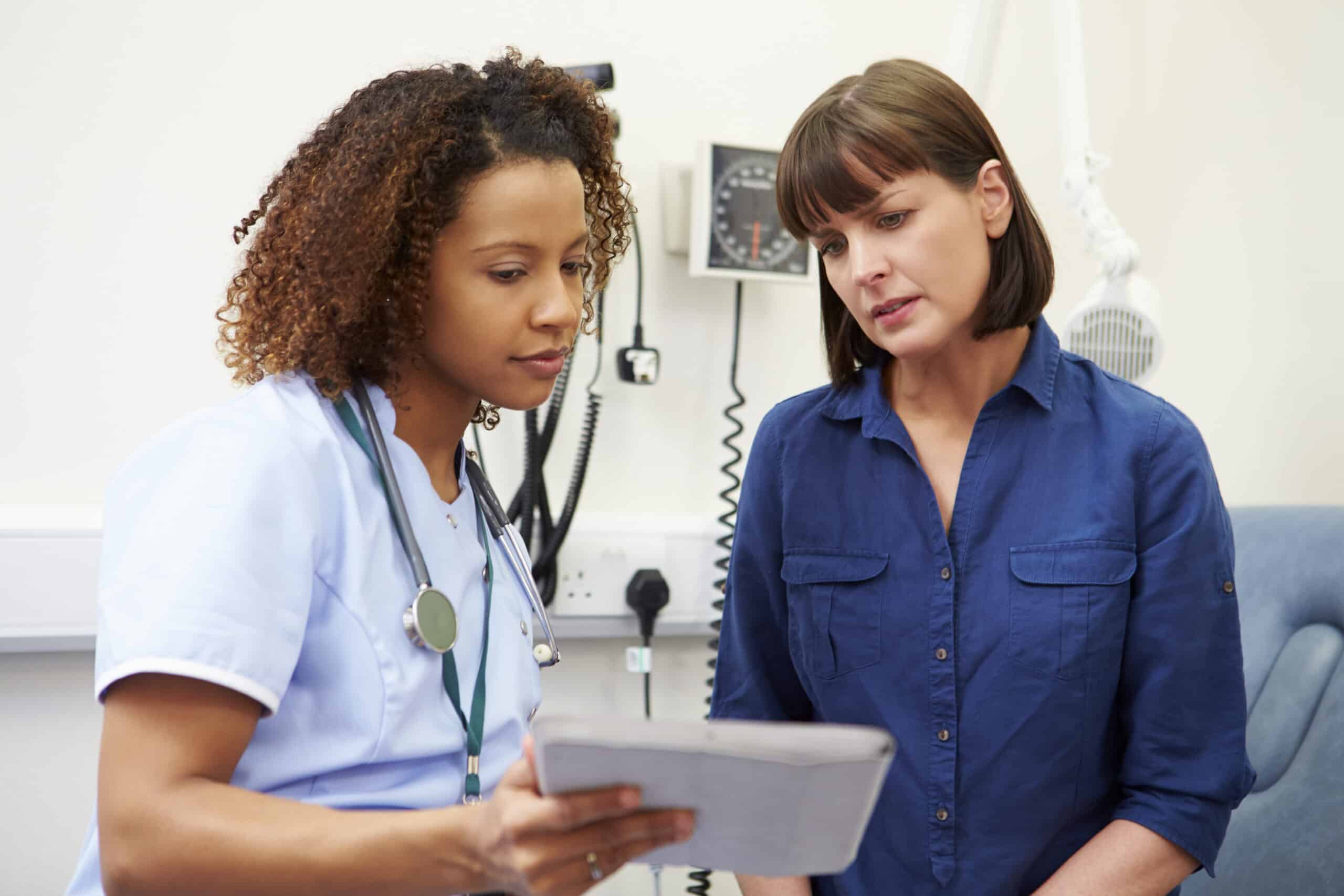 WomanInDoctorsOfficeWithNurse.