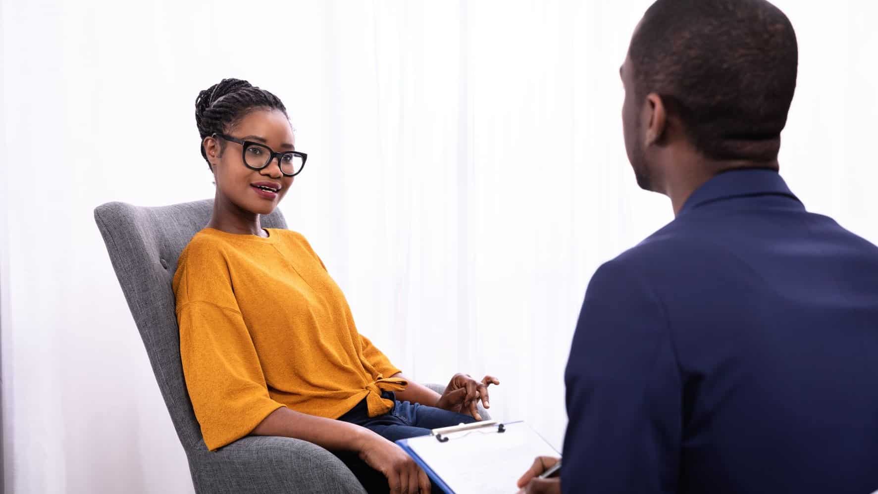 Woman sitting in an office, talking to her mental health professional.