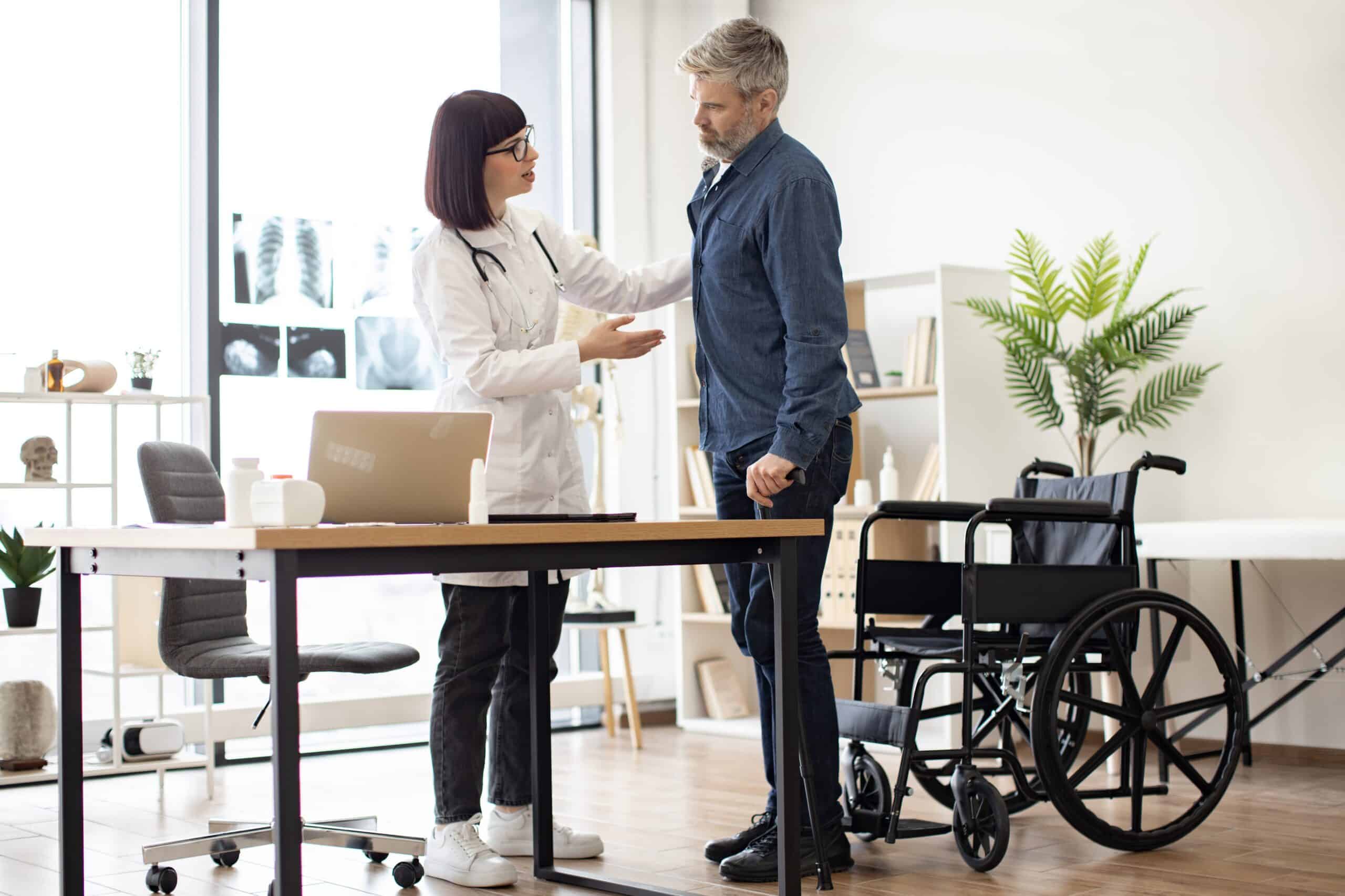 Man discussing mobility aids with doctor