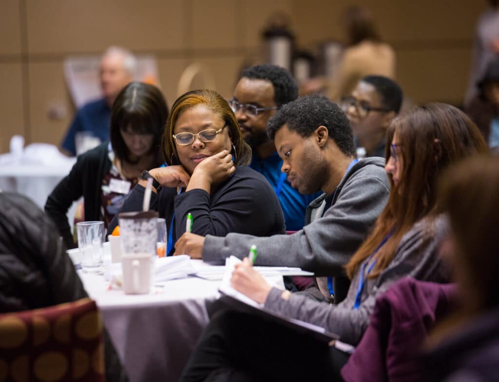 mother and son taking notes at an MS multiple sclerosis education program