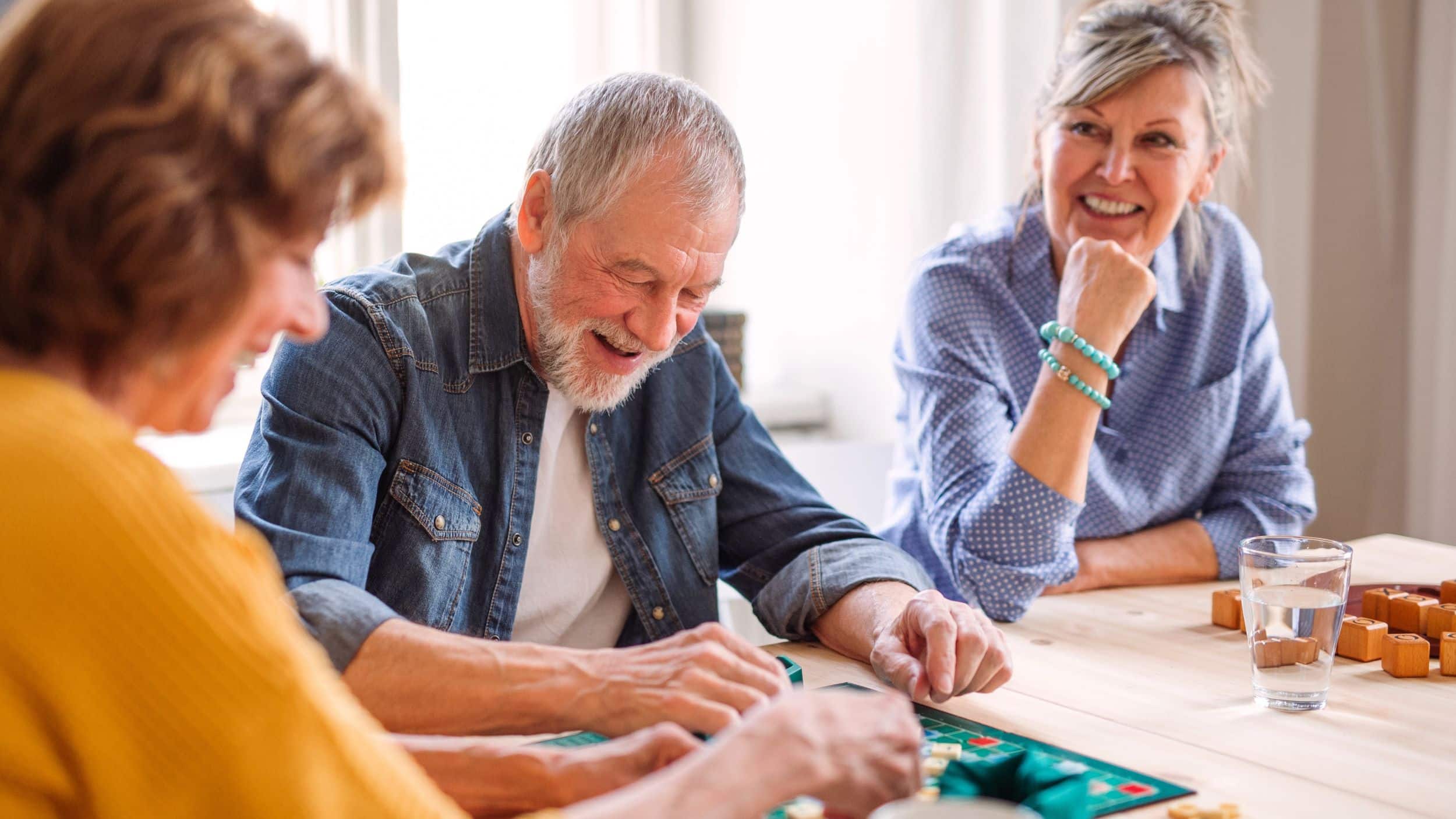 Group of older friends playing board game