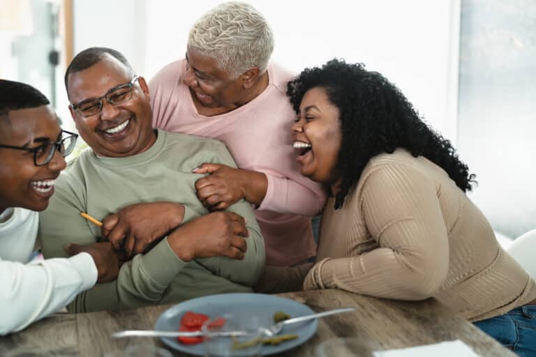 family laughing together at a dinner table