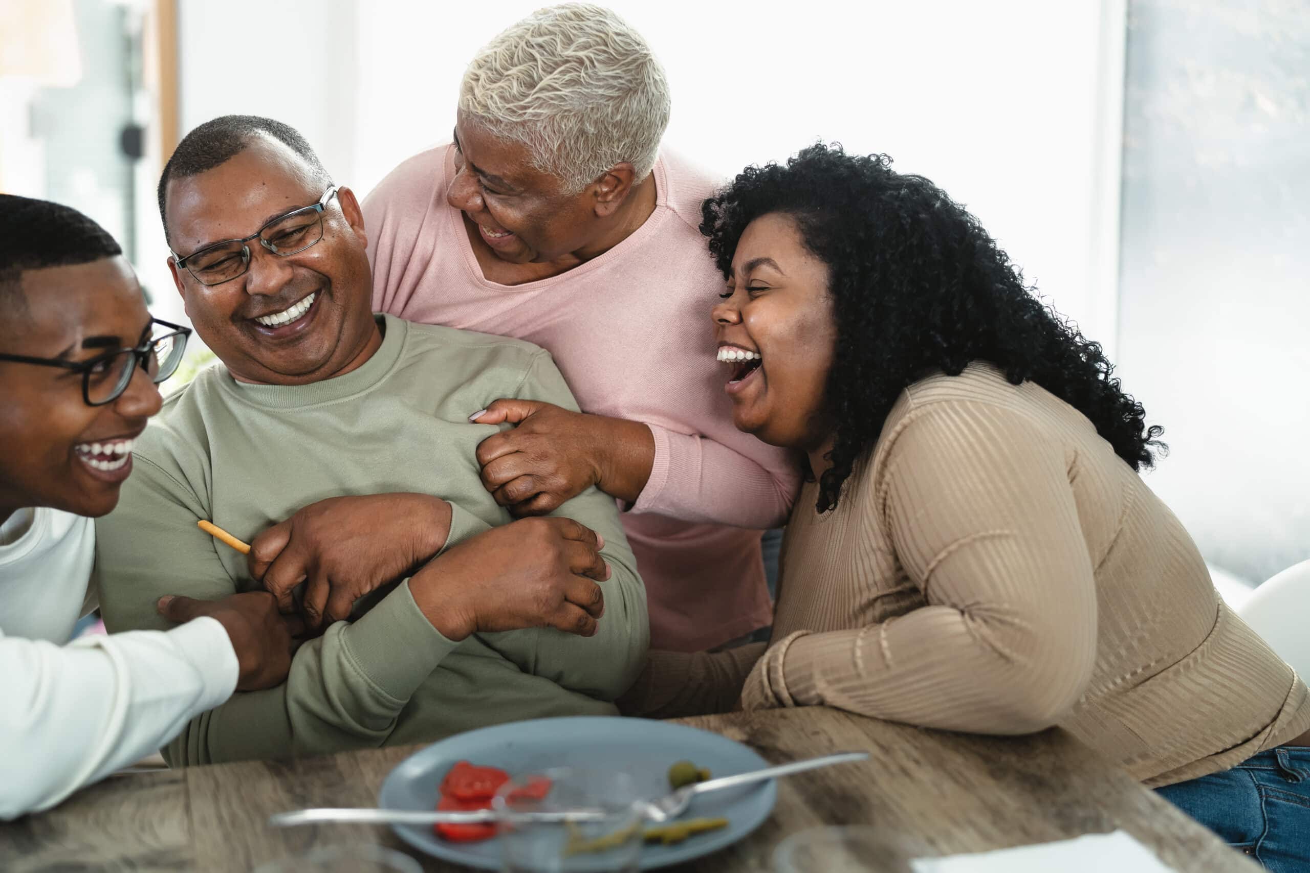 family laughing together at a dinner table