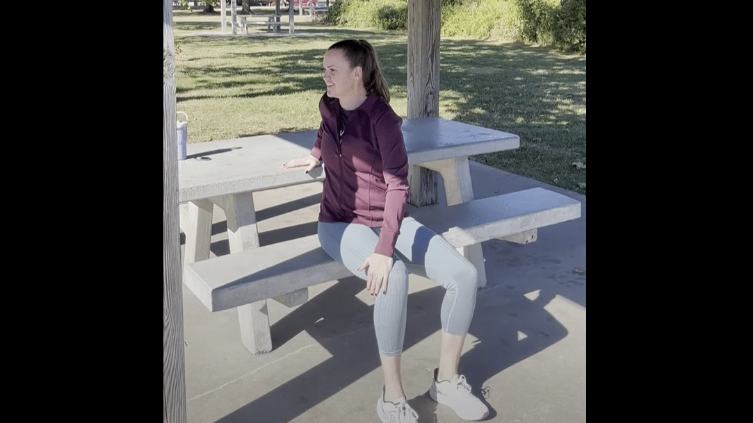 Emily Reilly sitting outside stretching