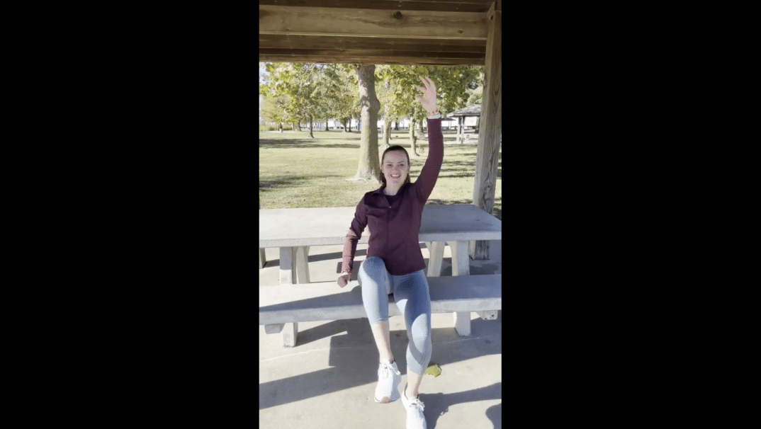 Emily Reilly performing a cardio exercise outside